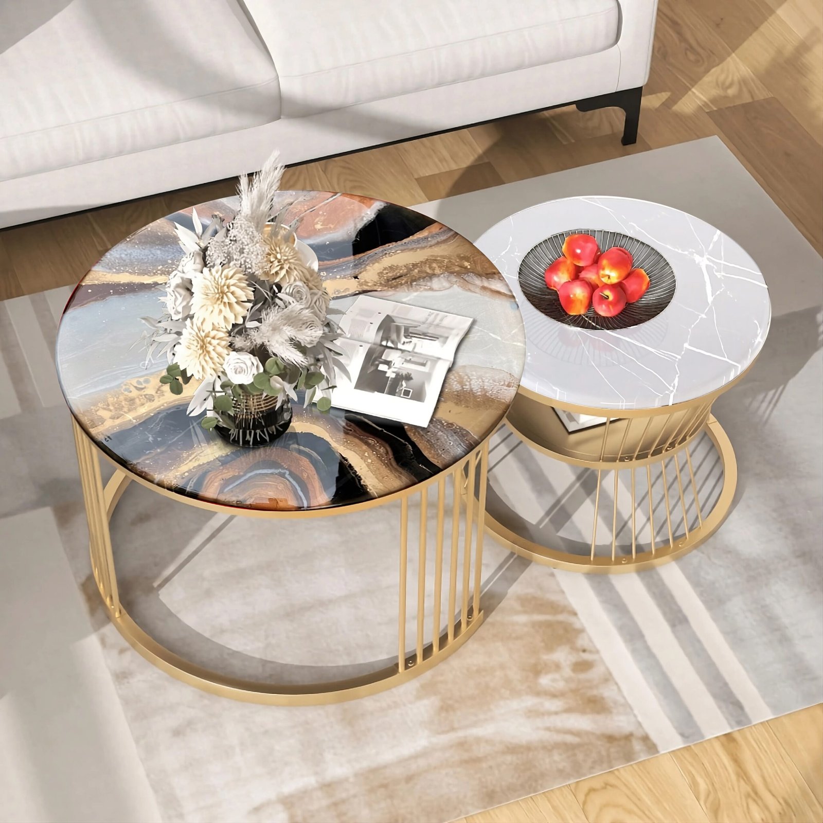 Elegant set of two round nesting coffee tables featuring luxurious tops; one showcases a detailed resin art piece with earthy and blue tones